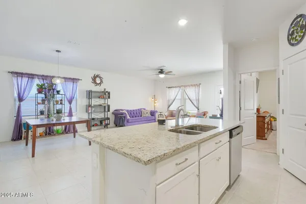a kitchen with stainless steel appliances granite countertop a sink and cabinets