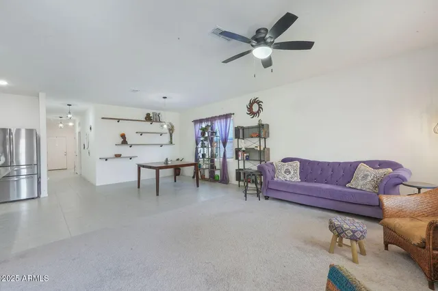 a living room with furniture and kitchen view
