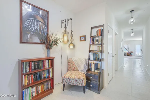 a living room with furniture and a book shelf
