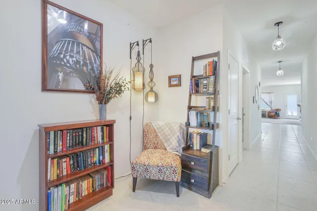 a living room with furniture and a book shelf