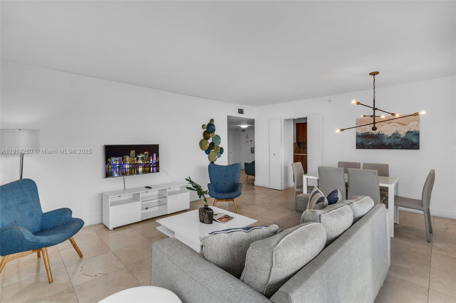 5101 Collins Avenue, Unit 12B Miami Beach, FL 33140 - Photo 4 of 13 a living room with furniture and a wooden floor