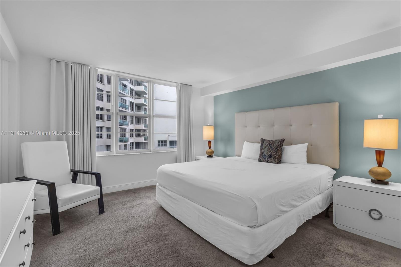 5101 Collins Avenue, Unit 12B Miami Beach, FL 33140 - Photo 10 of 13 a bedroom with a bed and a chair