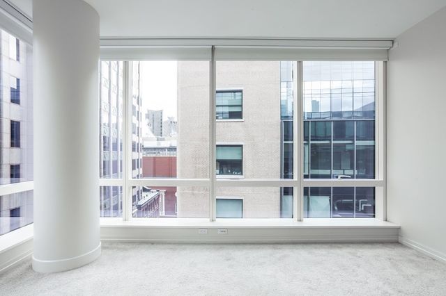 a view of wooden floor and windows in a room