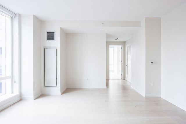 a view of an empty room with a fireplace