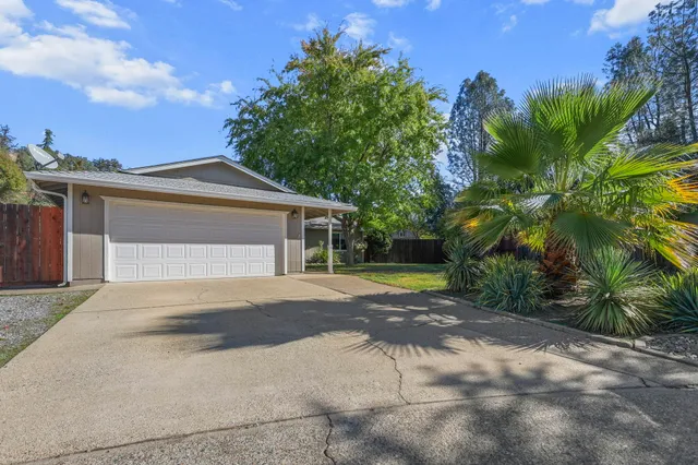 a front view of a house with a yard and a garage