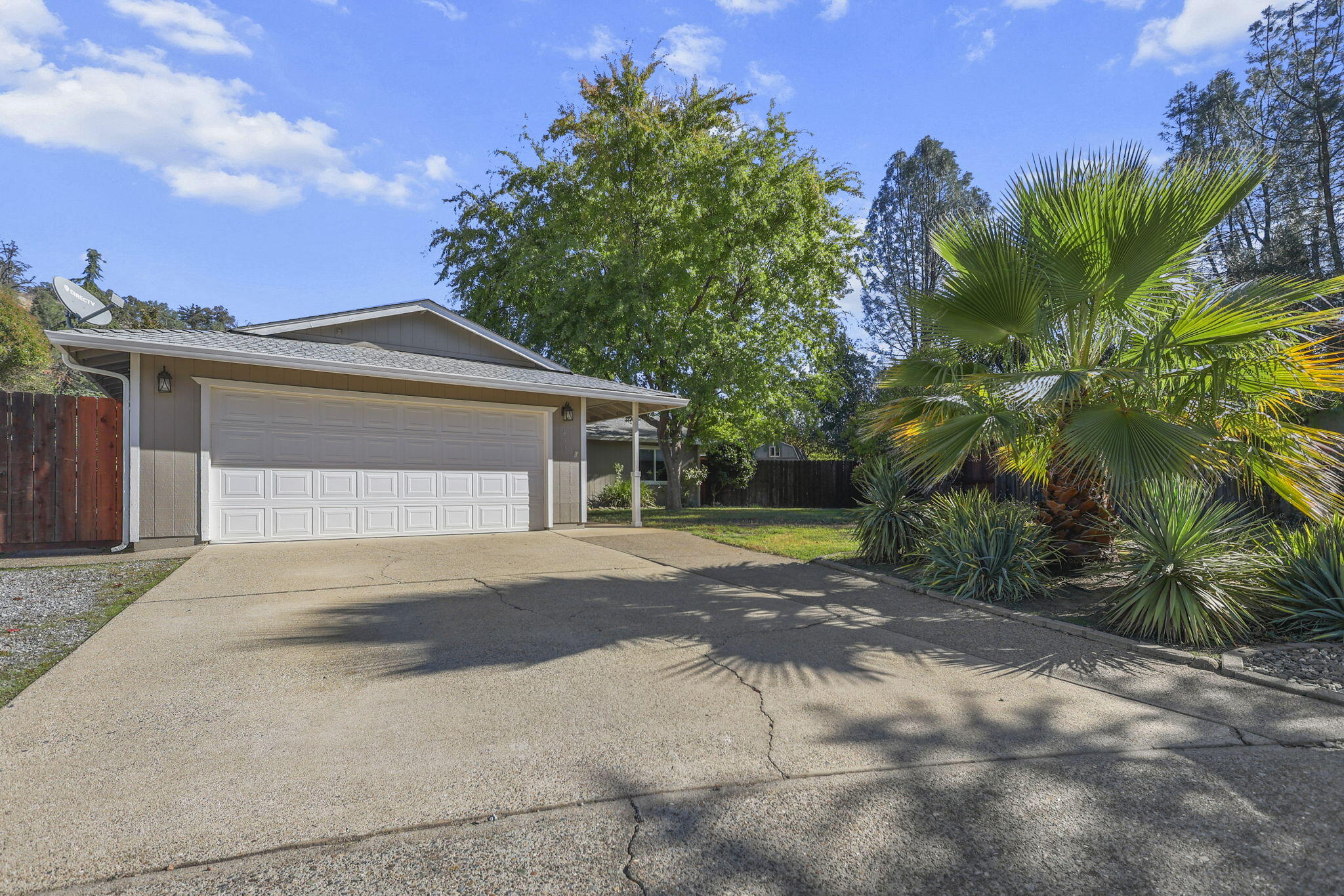 a front view of a house with a yard and a garage
