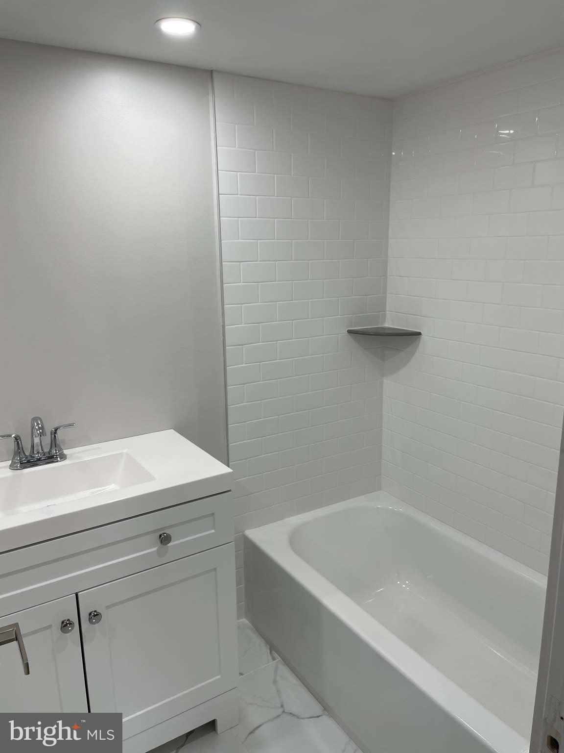 1305 Elson Road Brookhaven, PA 19015 - Photo 6 of 9 a bathroom with a bathtub and a sink