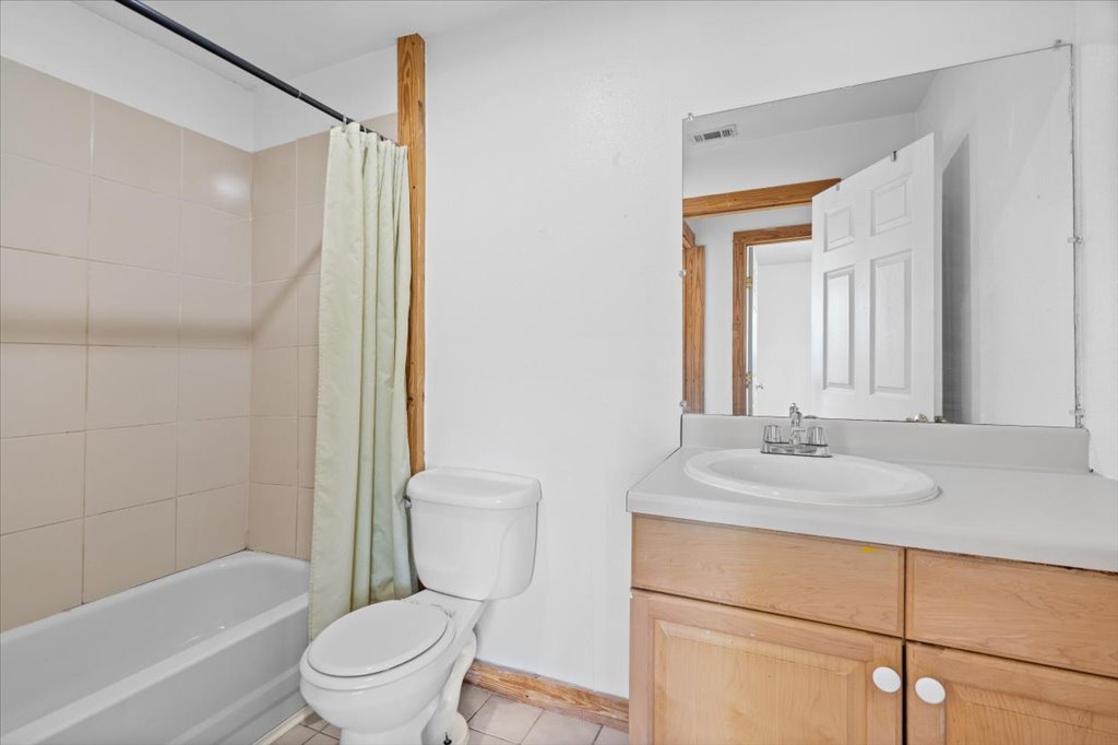 555 Harmon Hills Road, Unit A Dripping Springs, TX 78620 - Photo 24 of 29 A compact full bath offers a clean tub-shower combo and a convenient vanity for daily routines.