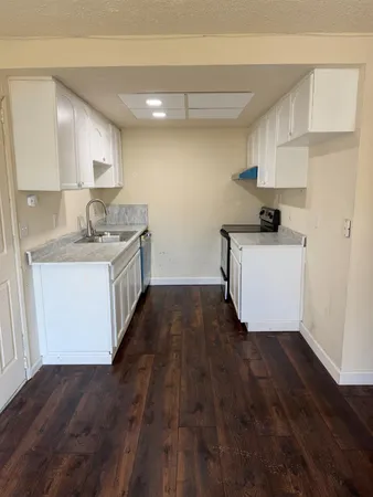 a kitchen with a sink and cabinets