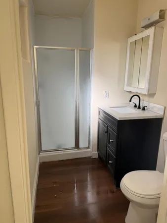 a bathroom with a sink a toilet and a mirror