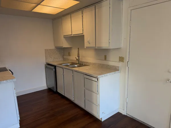 a kitchen with stainless steel appliances granite countertop a sink stove and cabinets