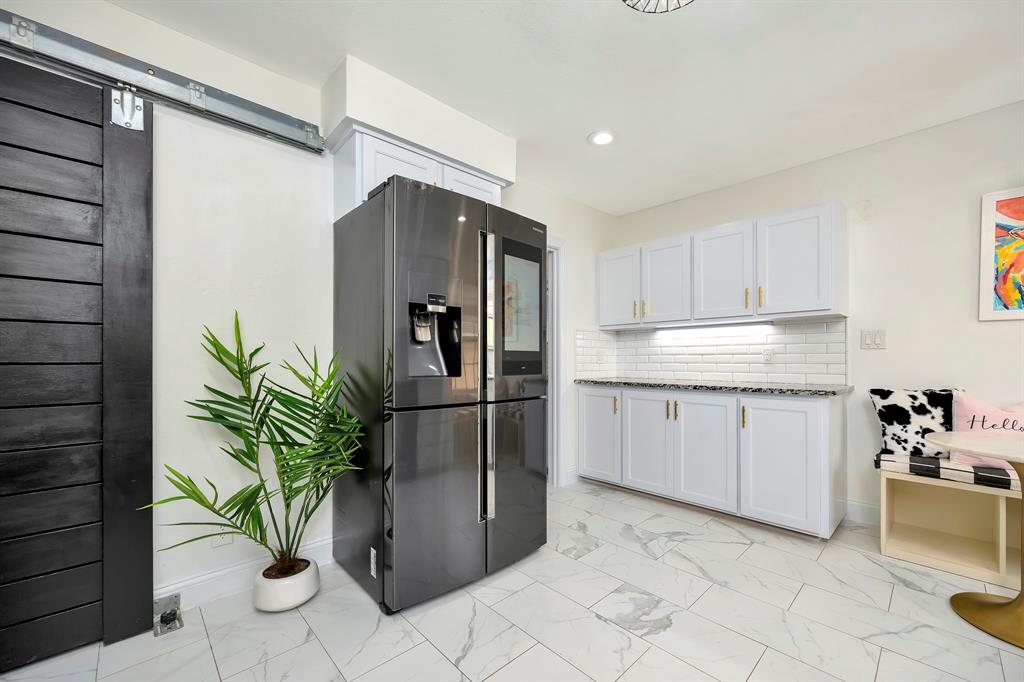 3413 Westcliff Road South Fort Worth, TX 76109 - Photo 14 of 26 a kitchen with stainless steel appliances a refrigerator a sink and cabinets