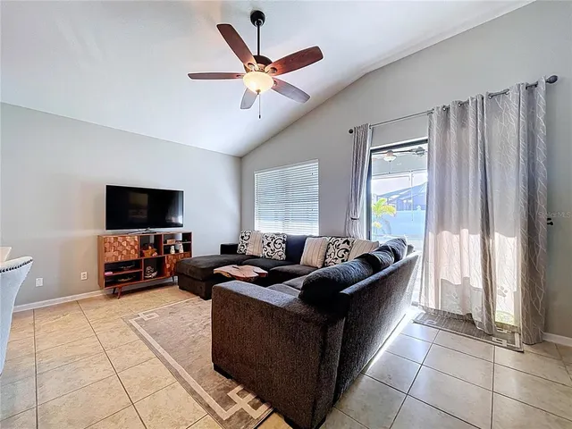 a spacious bedroom with a bed and painting on the wall