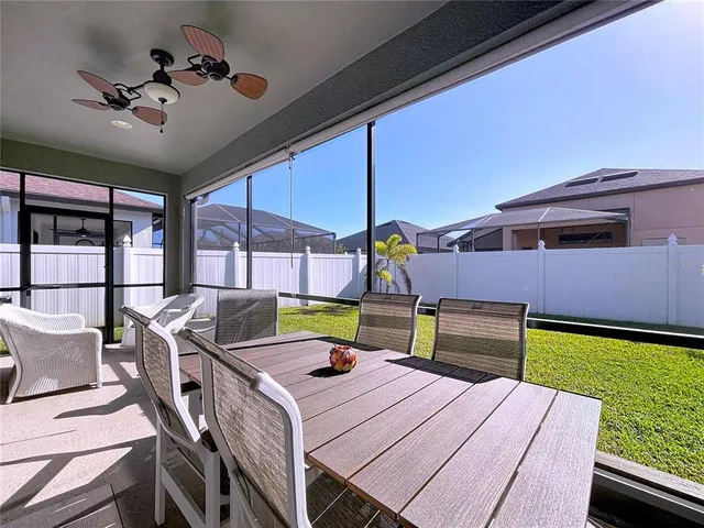 a living room with furniture kitchen view and a window