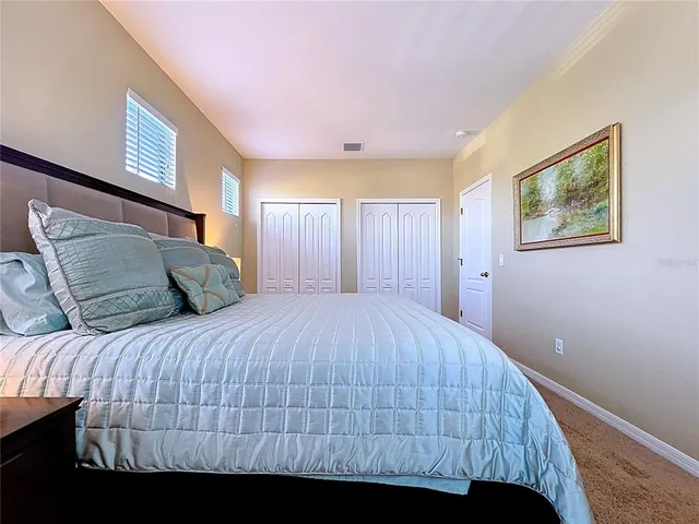 a spacious bathroom with a double vanity sink a large mirror and shower