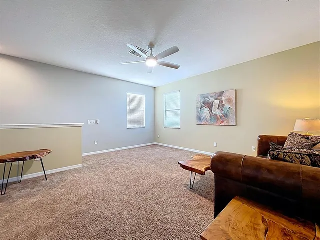 a bathroom with a granite countertop sink a toilet and a mirror