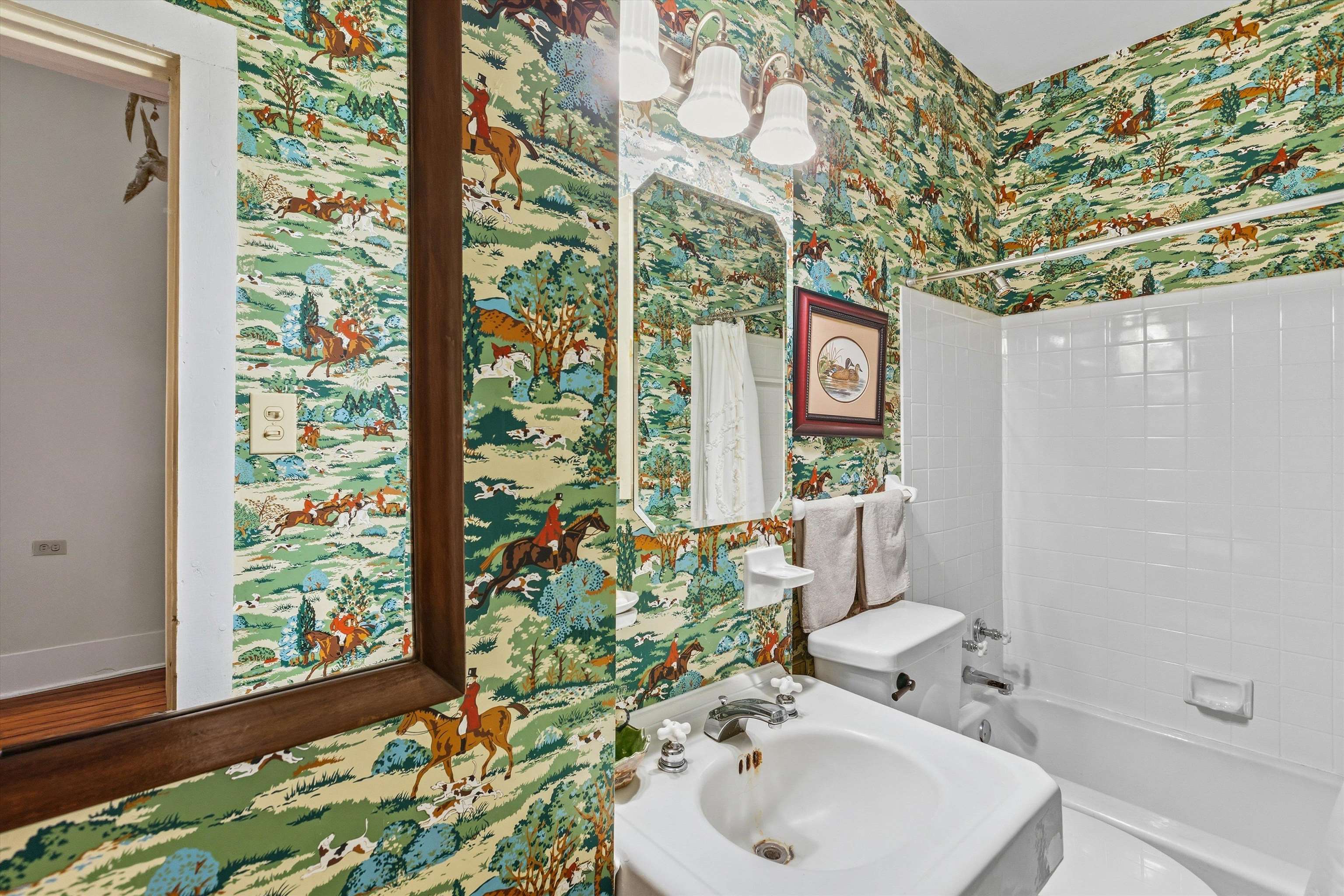 8516 Dogwood Road Germantown, TN 38139 - Photo 10 of 40 Downstairs shared bath w/ whimsical wallpaper.