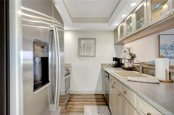a view of a kitchen with a sink and dishwasher