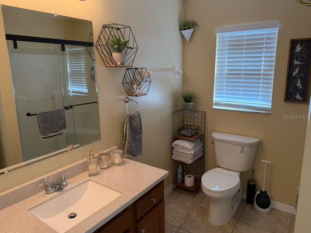 328 Robin Road Davenport, FL 33896 - Photo 13 of 17 a bathroom with a toilet sink and mirror