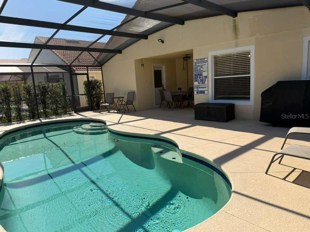 328 Robin Road Davenport, FL 33896 - Photo 17 of 17 a outdoor kitchen with a sink and view of living room