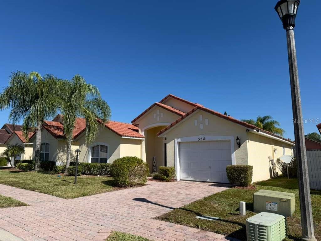 328 Robin Road Davenport, FL 33896 - Photo 2 of 17 a front view of a house with garden