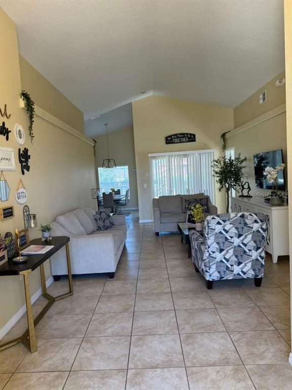 328 Robin Road Davenport, FL 33896 - Photo 3 of 17 a living room with furniture and a potted plant