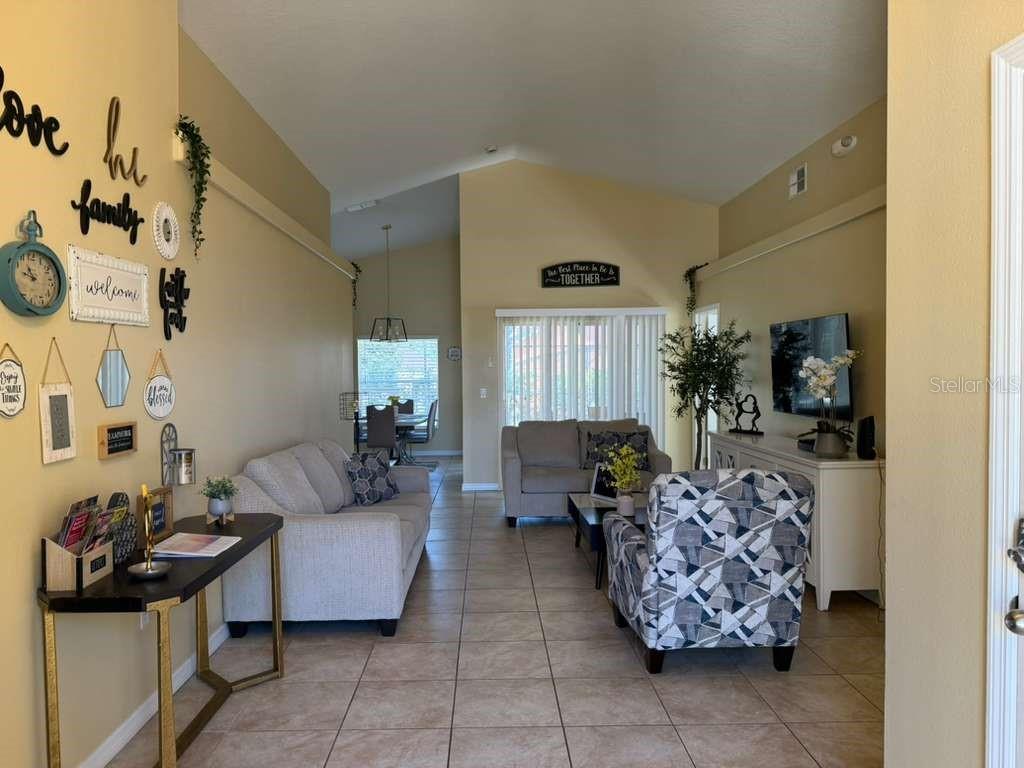 328 Robin Road Davenport, FL 33896 - Photo 4 of 17 a living room with furniture and a flat screen tv