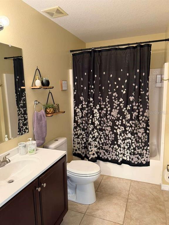 328 Robin Road Davenport, FL 33896 - Photo 6 of 17 a bathroom with a sink toilet and shower