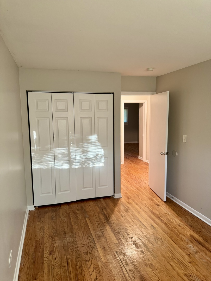 16919 Western Avenue Hazel Crest, IL 60429 - Photo 14 of 21 wooden floor in an empty room with a window