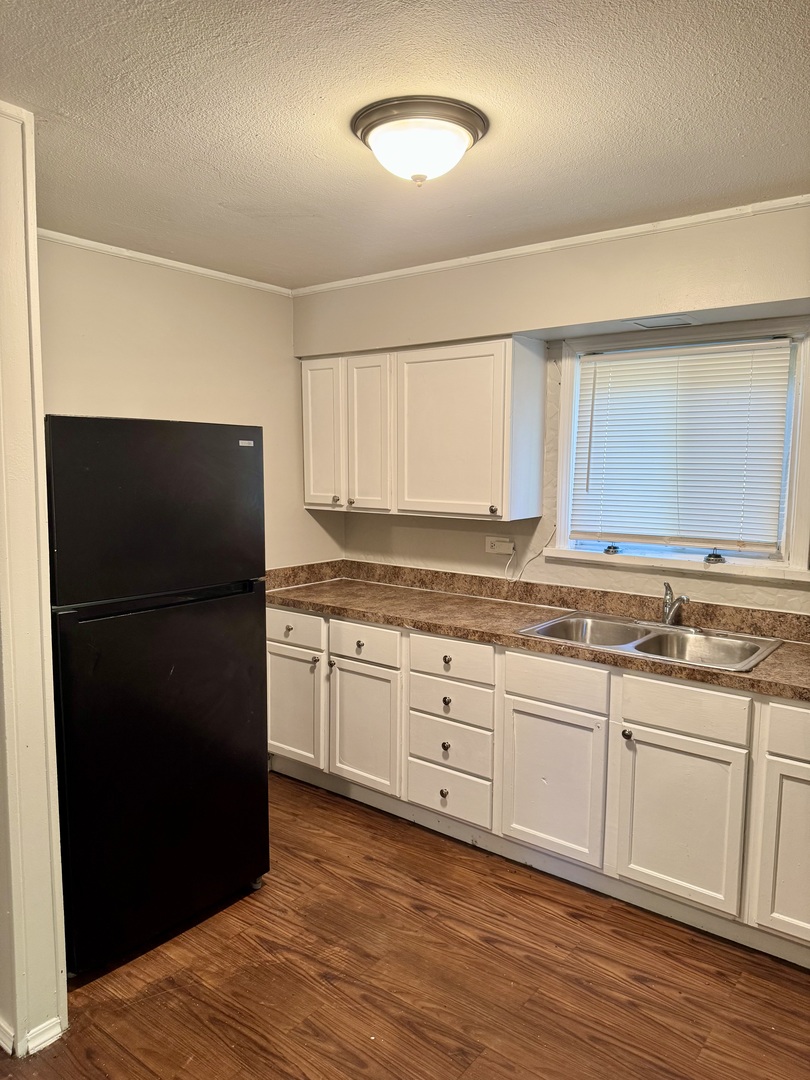 16919 Western Avenue Hazel Crest, IL 60429 - Photo 5 of 21 a kitchen with granite countertop white cabinets and refrigerator