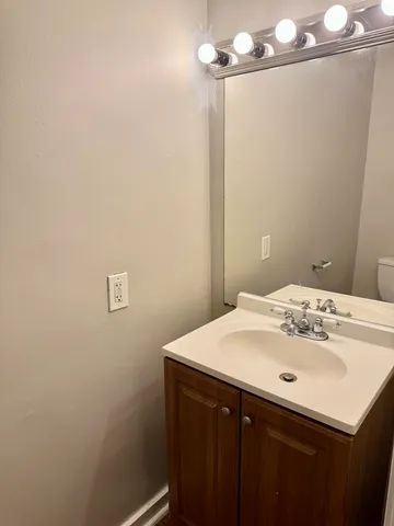 a bathroom with a sink vanity and a mirror