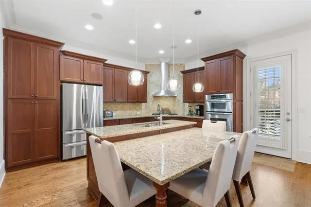 a large bathroom with double vanity sinks a large mirror and a bathtub next to a window