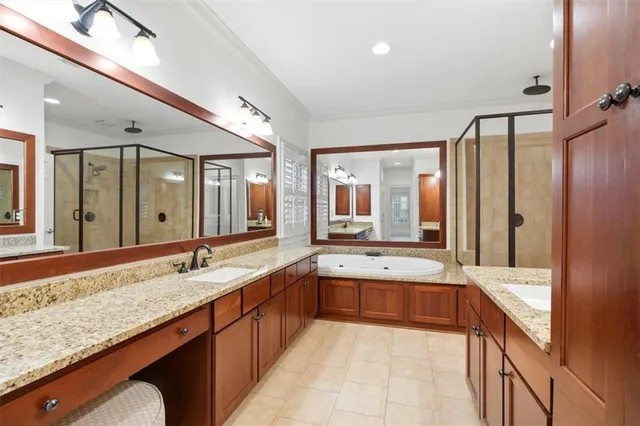 a bedroom with a bed a couch and a window