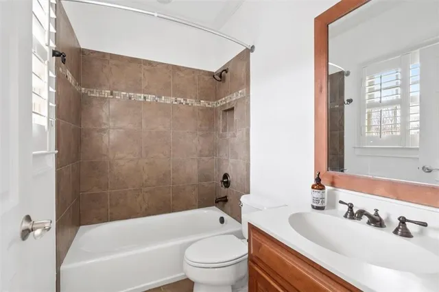 a view of a white building among the street with palm trees