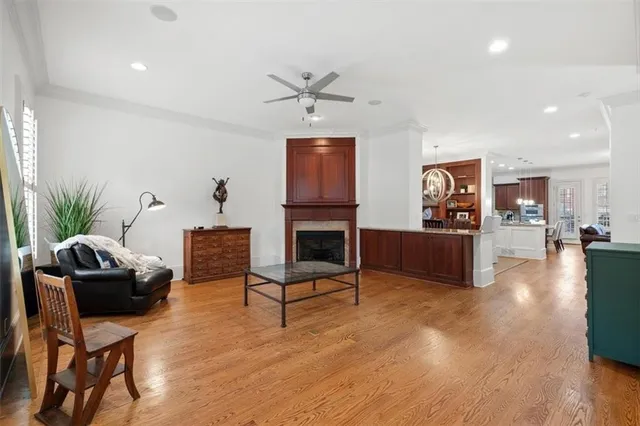 a kitchen with stainless steel appliances granite countertop a refrigerator a stove a sink a dining table and chairs