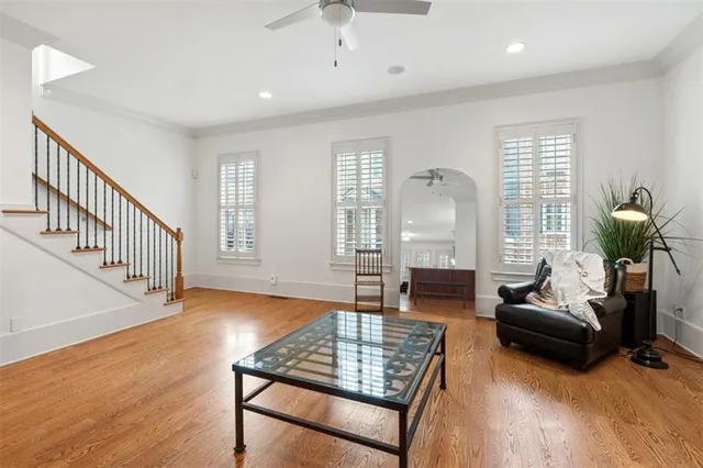 a kitchen with stainless steel appliances granite countertop a refrigerator a stove a sink a dining table and chairs