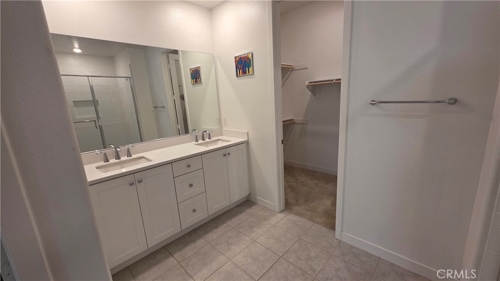 26955 West Prospector Road, Unit 201 Valencia, CA 91381 - Photo 16 of 30 a spacious bathroom with a double vanity sink a mirror and a