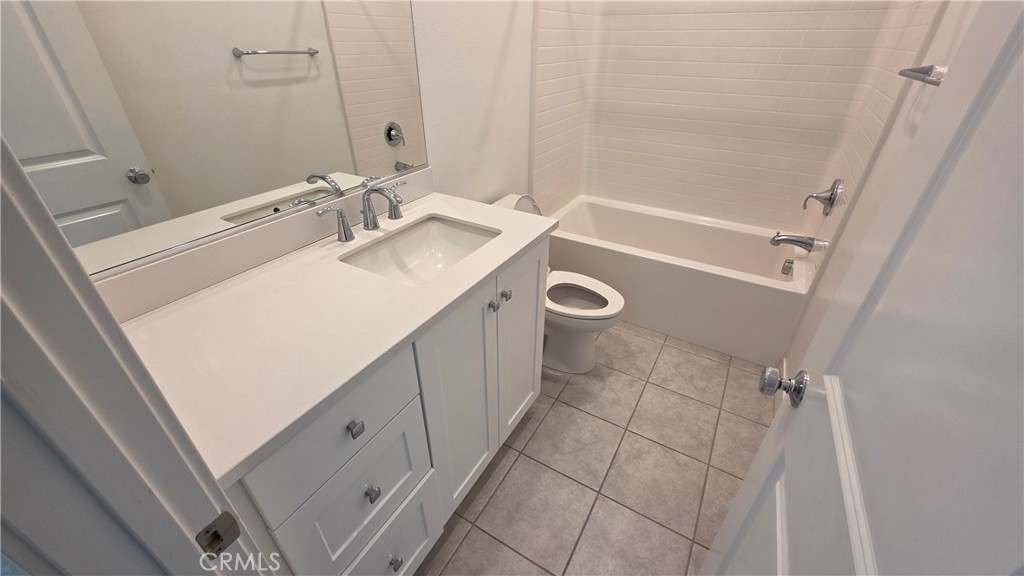 26955 West Prospector Road, Unit 201 Valencia, CA 91381 - Photo 23 of 30 a bathroom with a sink a toilet and shower