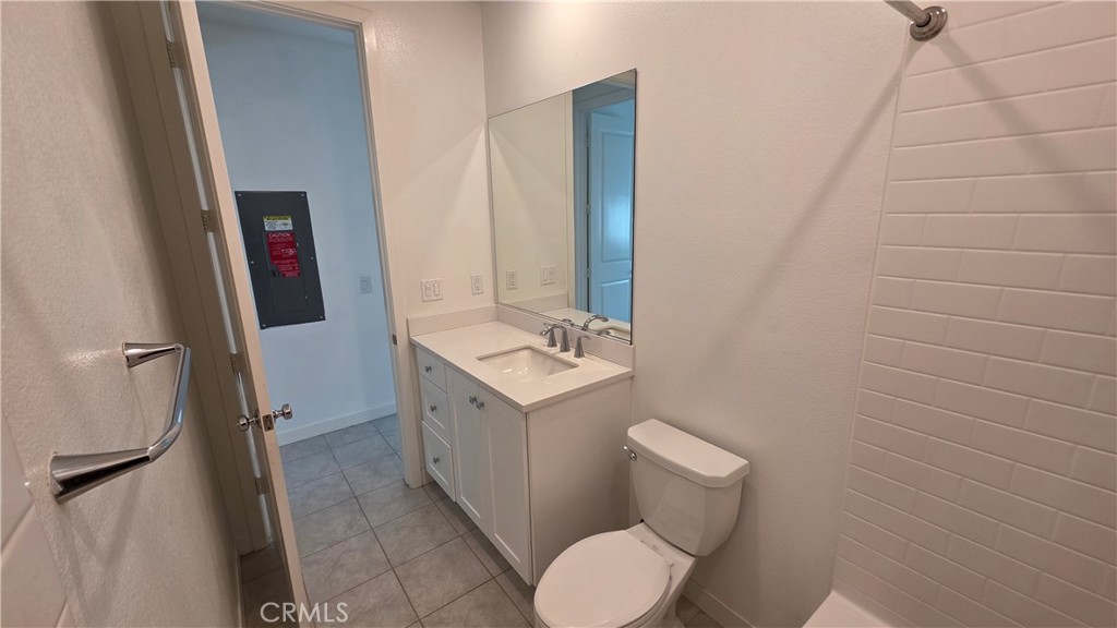 26955 West Prospector Road, Unit 201 Valencia, CA 91381 - Photo 24 of 30 a bathroom with a sink vanity mirror and toilet