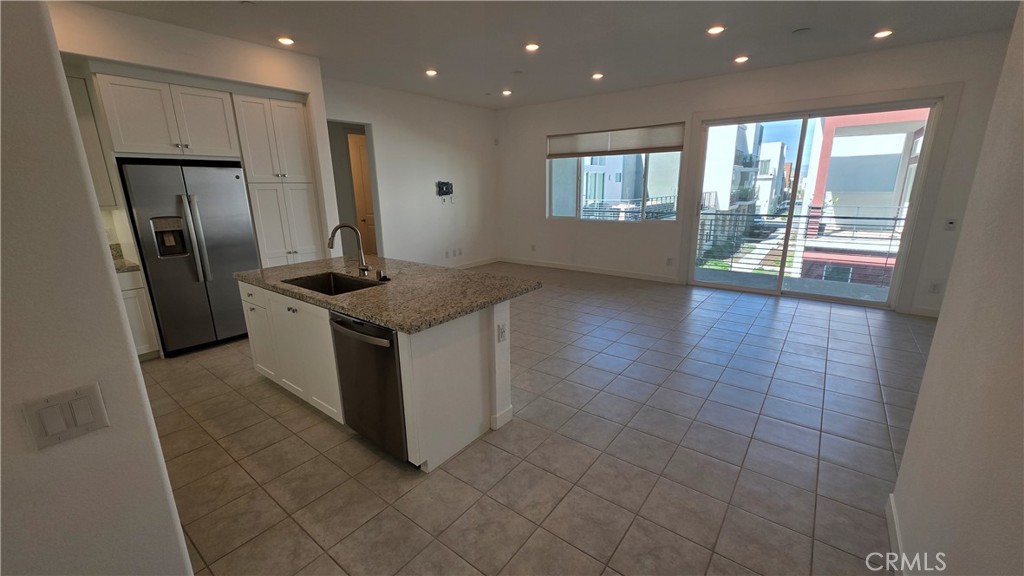 26955 West Prospector Road, Unit 201 Valencia, CA 91381 - Photo 3 of 30 a kitchen with stainless steel appliances granite countertop a sink and a refrigerator