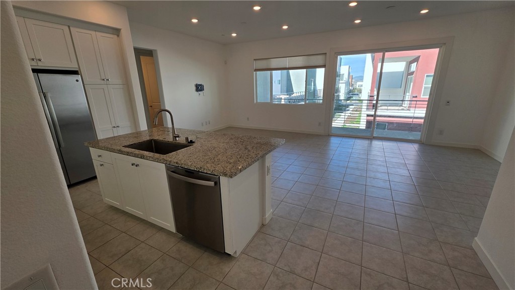 26955 West Prospector Road, Unit 201 Valencia, CA 91381 - Photo 4 of 30 a kitchen with a sink a counter top space cabinets and stainless steel appliances