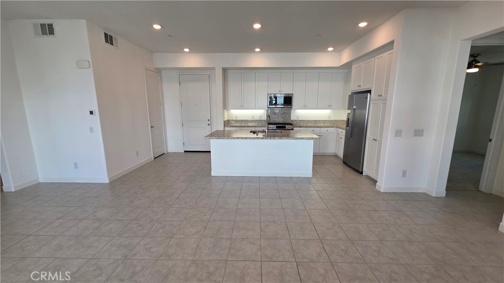 26955 West Prospector Road, Unit 201 Valencia, CA 91381 - Photo 6 of 30 a kitchen with stainless steel appliances a refrigerator and a stove