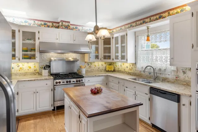 a kitchen with a stove a sink and a refrigerator