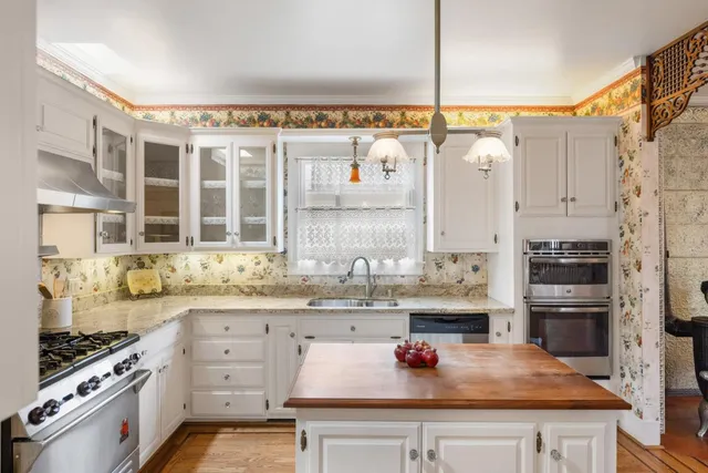 a kitchen with stainless steel appliances a sink stove and refrigerator