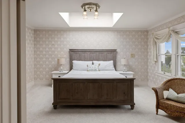 a bedroom with a bed and a chandelier
