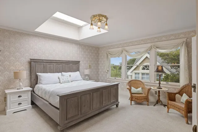 a bedroom with a bed chair and window