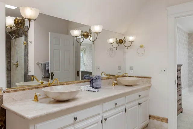 a bathroom with a sink a light fixture and a mirror