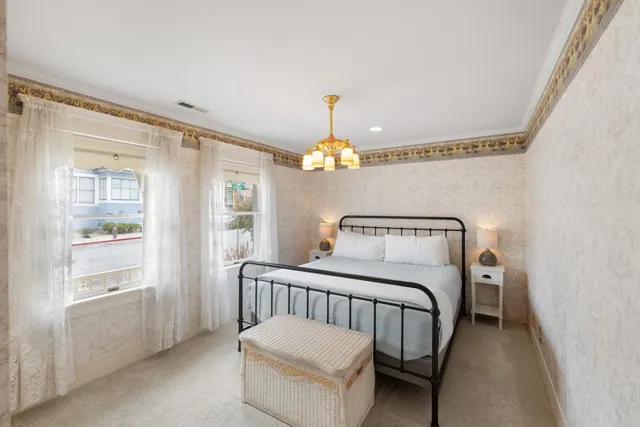 a bedroom with a bed and a chandelier