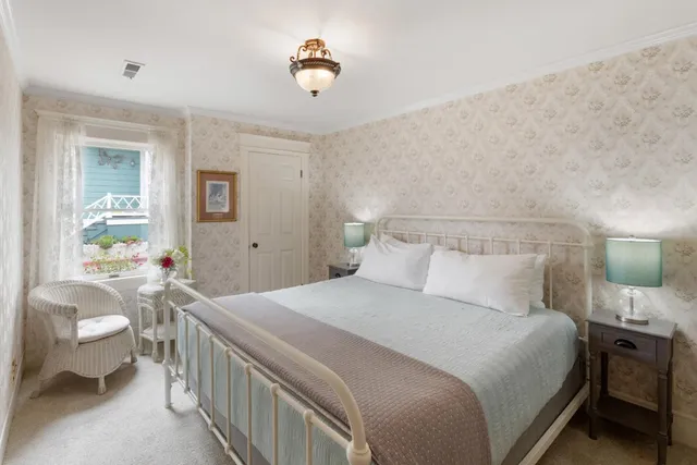 a bedroom with a bed and a mirror