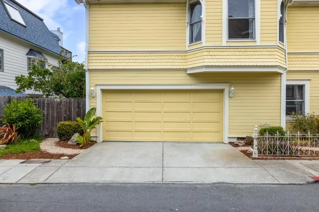 a small white house with outdoor space